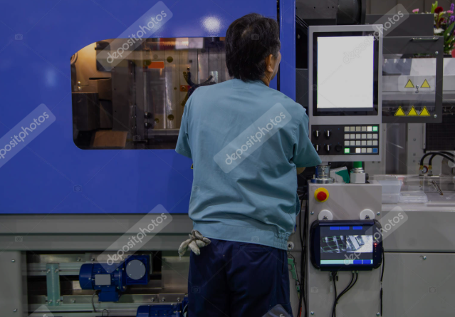 Modern industrial facility of Balaji Mould Tech showing clean manufacturing environment with injection molding machines and workers in safety gear
